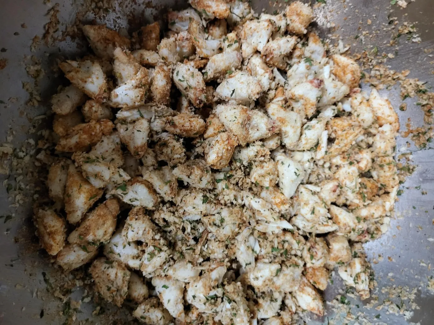 Seasoned jumbo lump crab meat in a mixing bowl