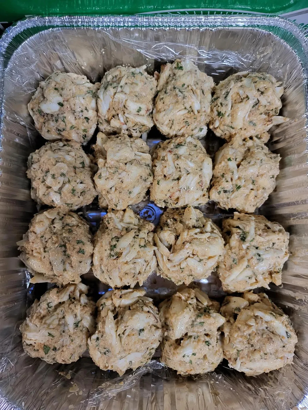 A tray of hand-formed crab cakes ready to cook