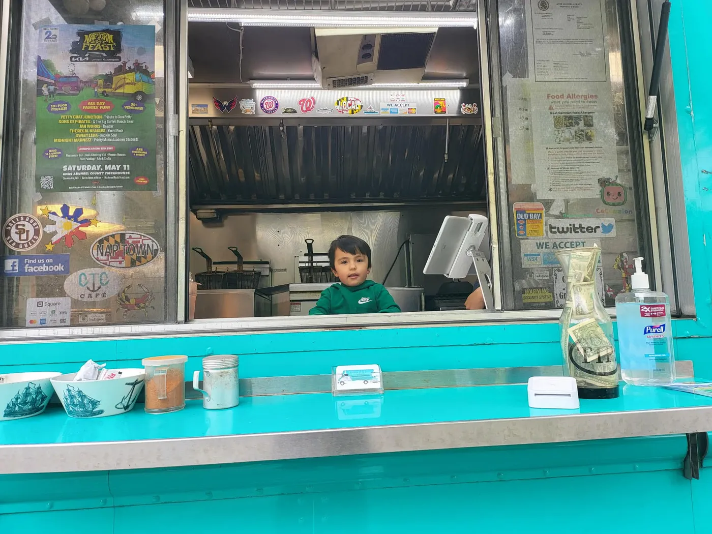 The owner's young son peeking over the counter inside the truck
