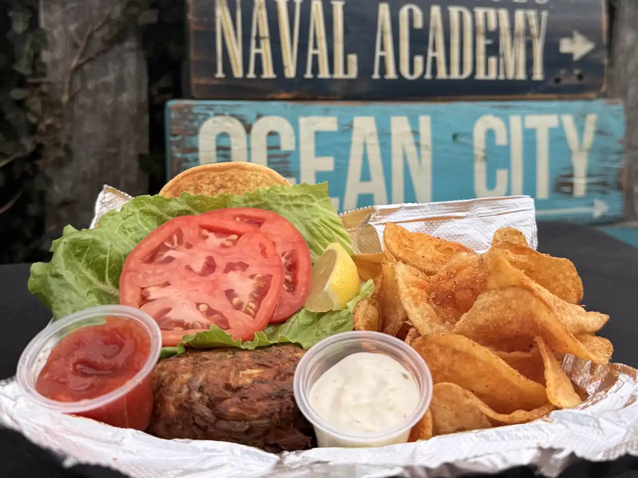 Crabcake sandwich with chips on a tray
