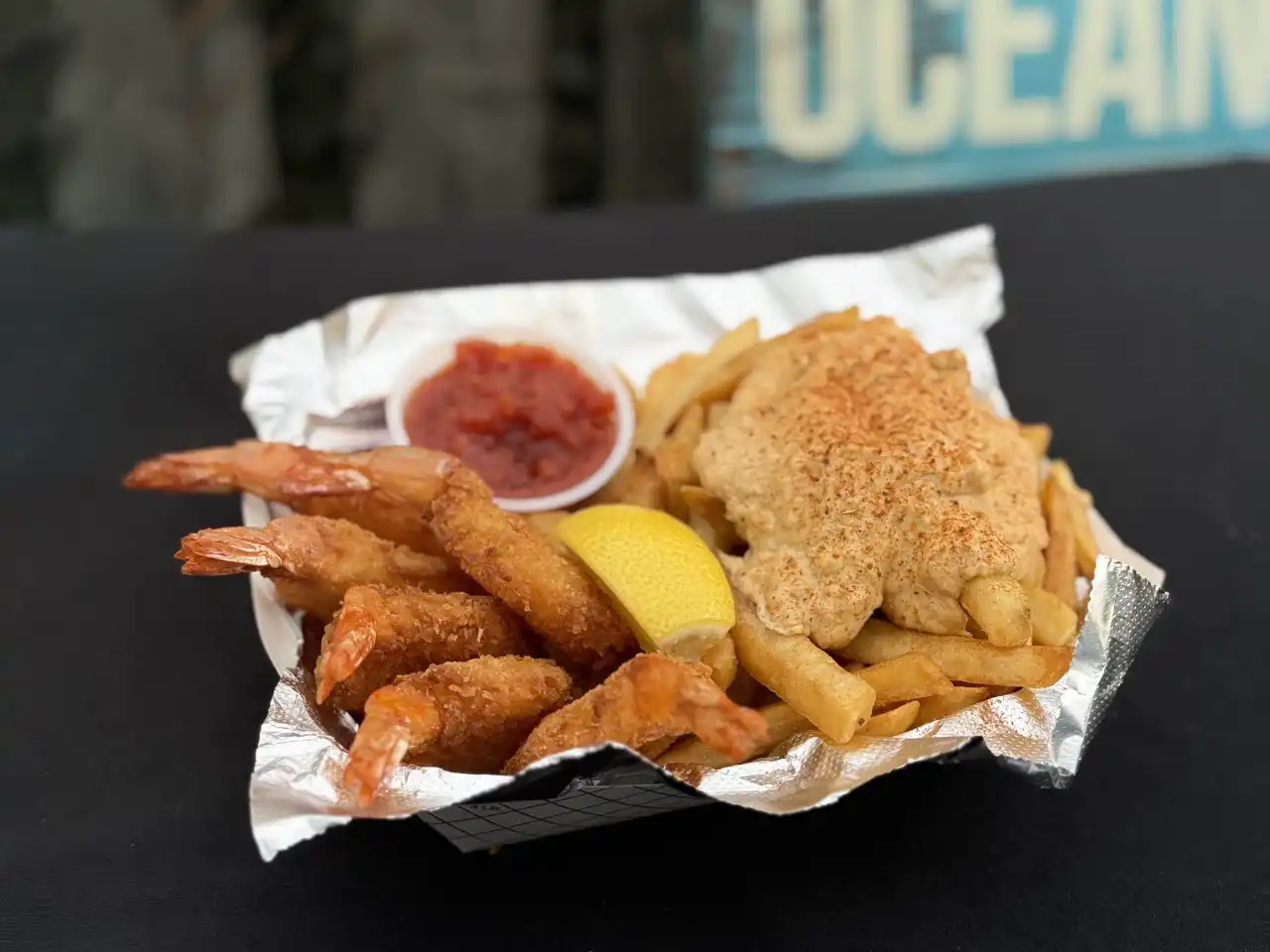Fried shrimp served over crabdip fries